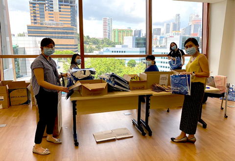 Various departments pitched in to pack some 1,500 care packs for all NHCS staff.