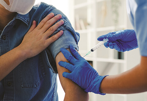 Nurse giving Covid-19 vaccine to man